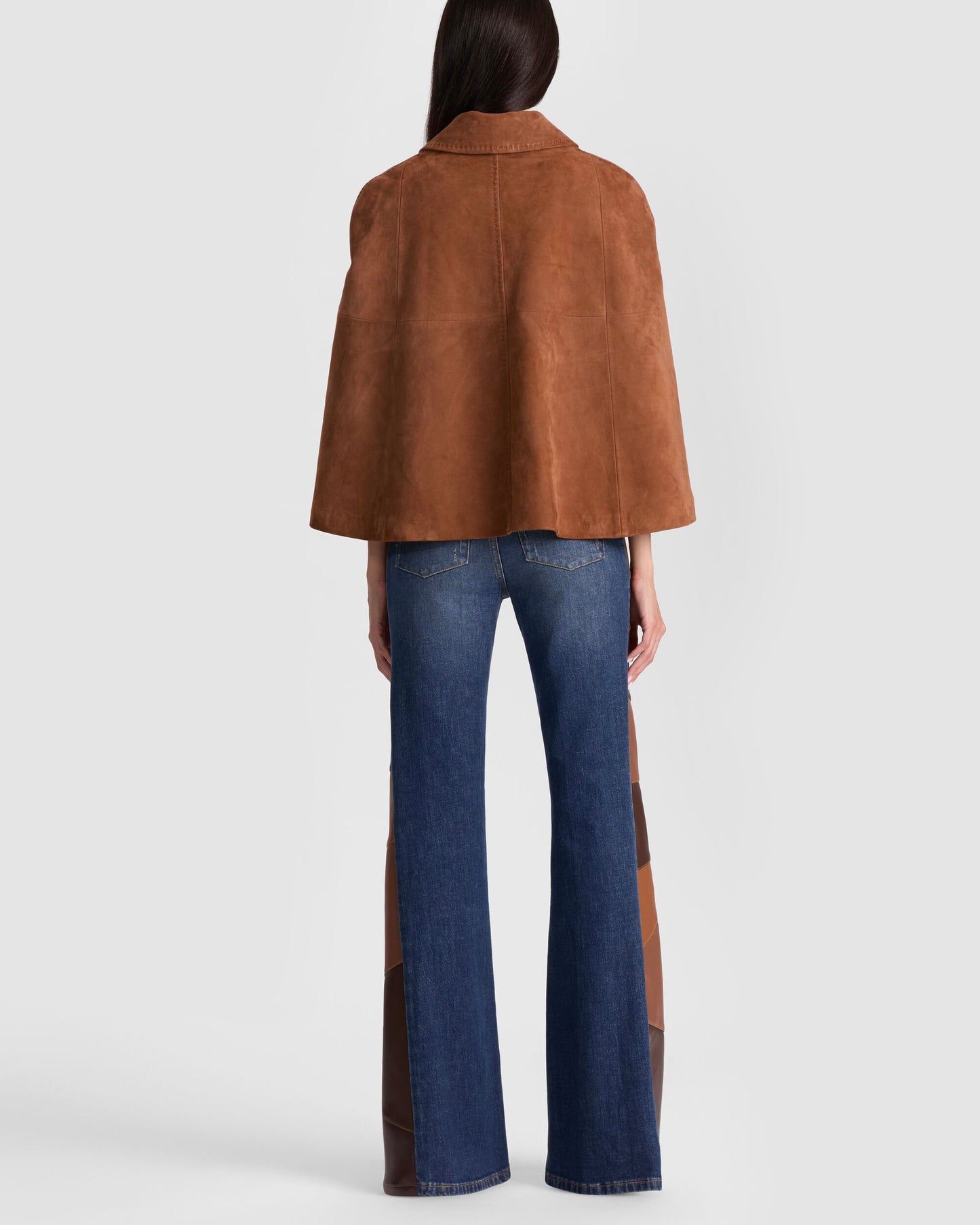 Text: Stylish brown suede cape jacket paired with denim, showcasing soft suede texture and timeless tailoring.
suede cape coat, brown suede fashion, chic fall look, American street style, suede outfit idea