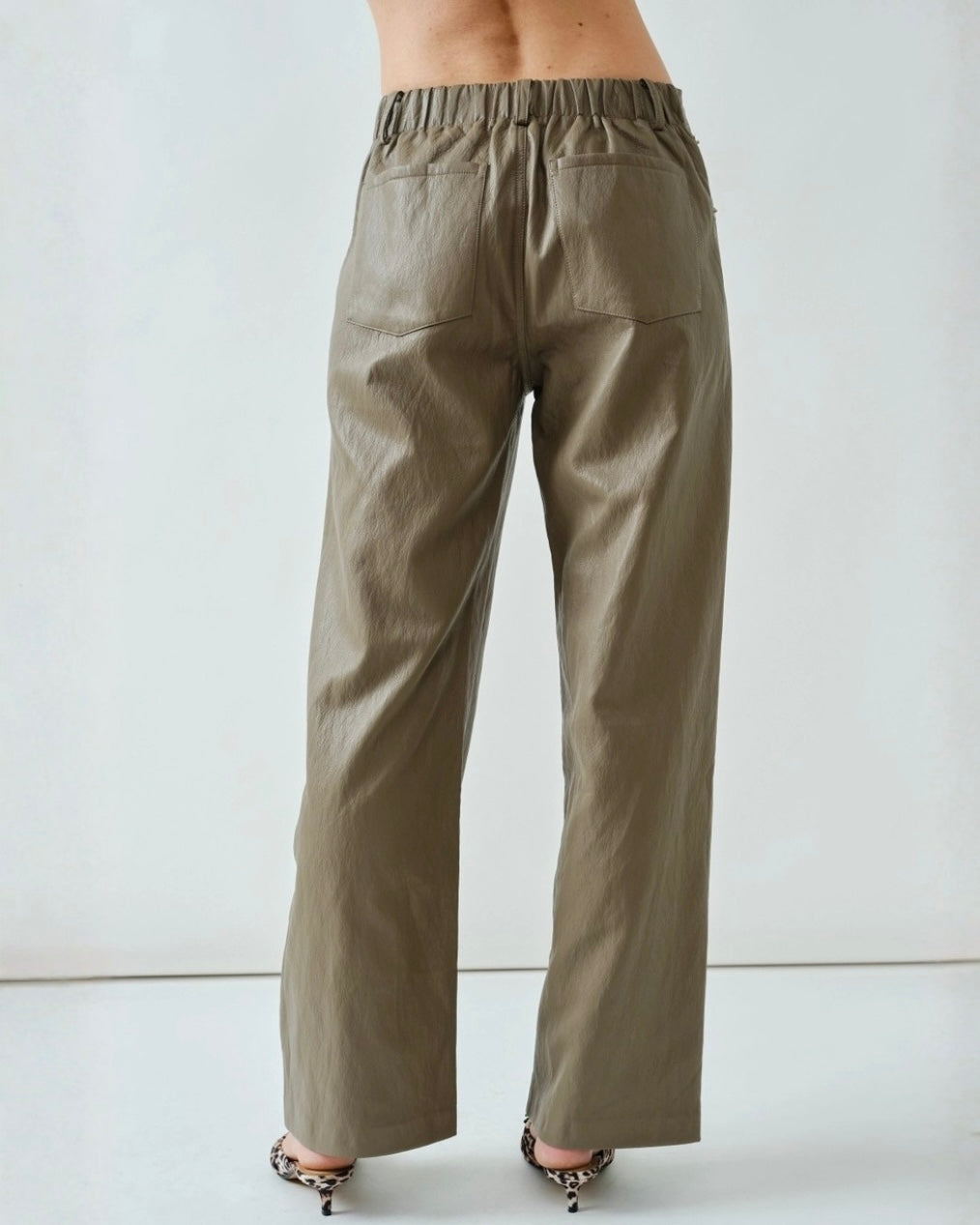 Chic brown faux leather pants with a clean silhouette, refined detailing, and a polished contemporary look.